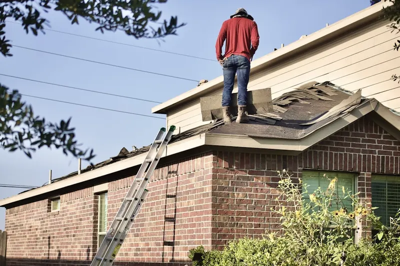 Professional roofer working on a residential roof in Buckhead